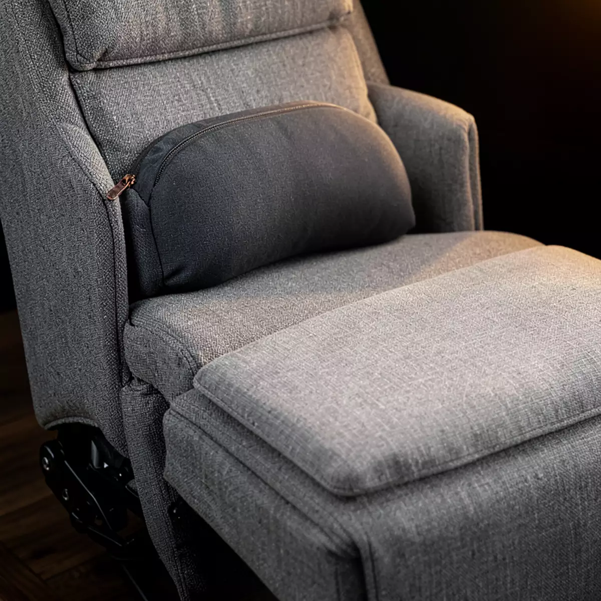 lumbar pillow and leg rest cushion on a recliner